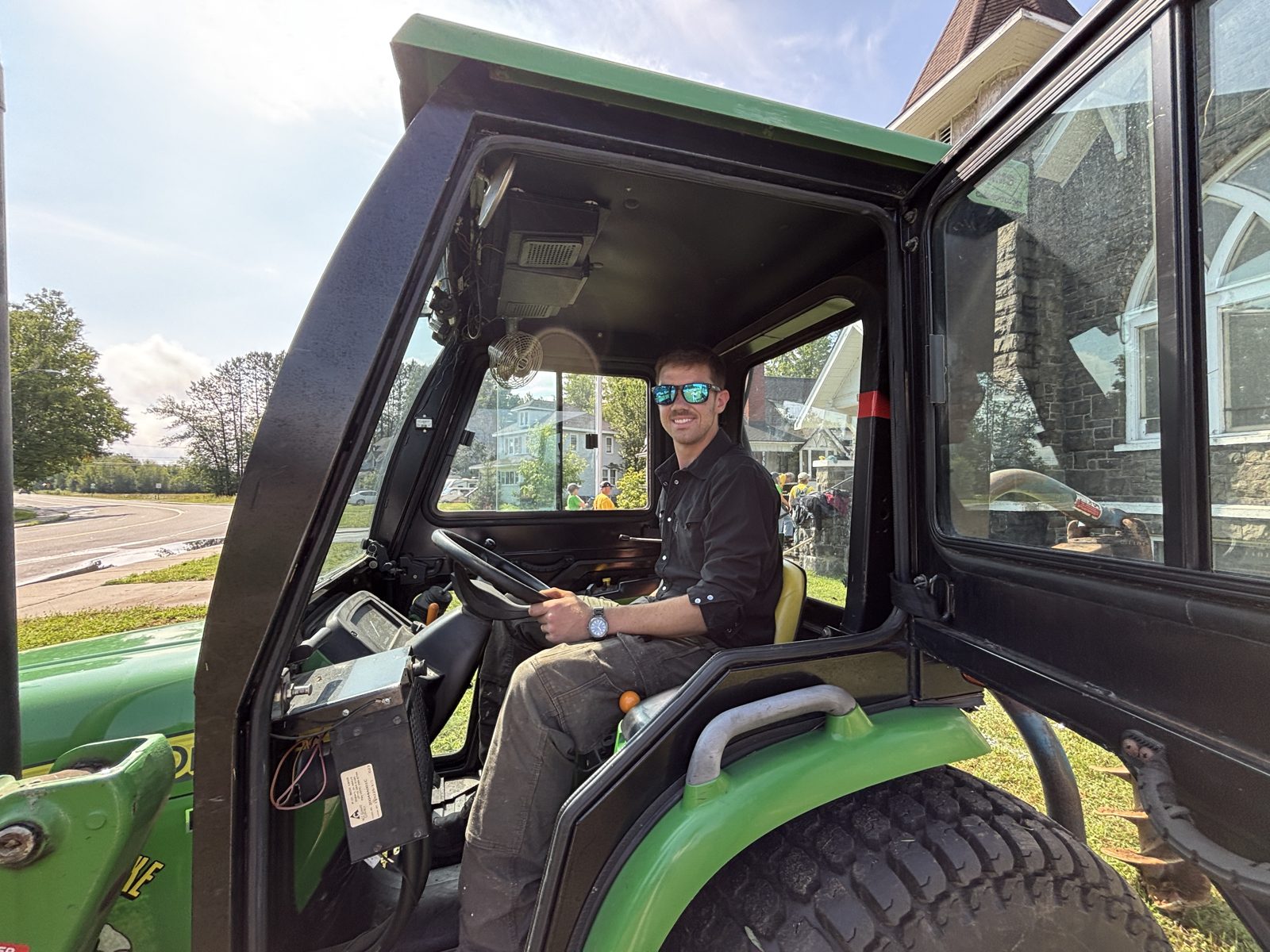 A Tupper Lake student at the controls of a tractor