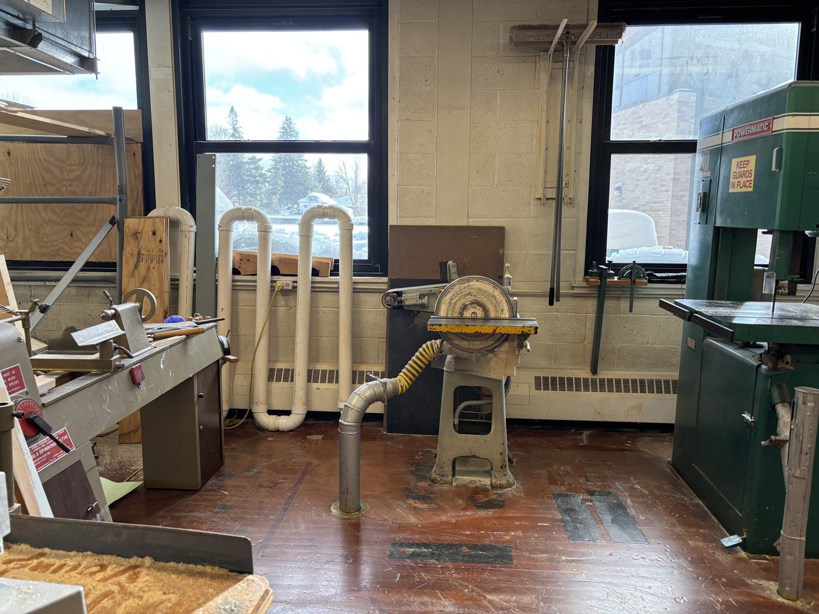 Older woodworking machines along the tech room wall
